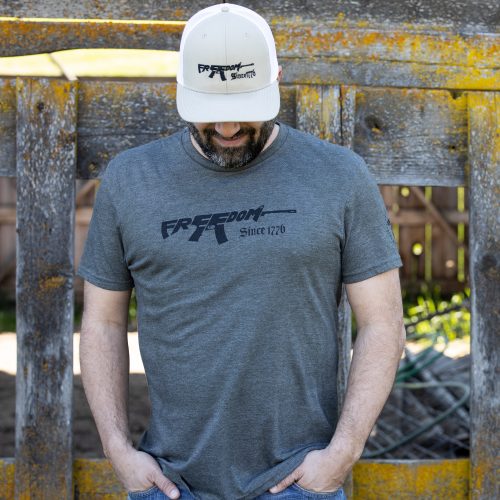 Man wearing olive green Freedom Rifle T-shirt from United States of American's Republic USOAR