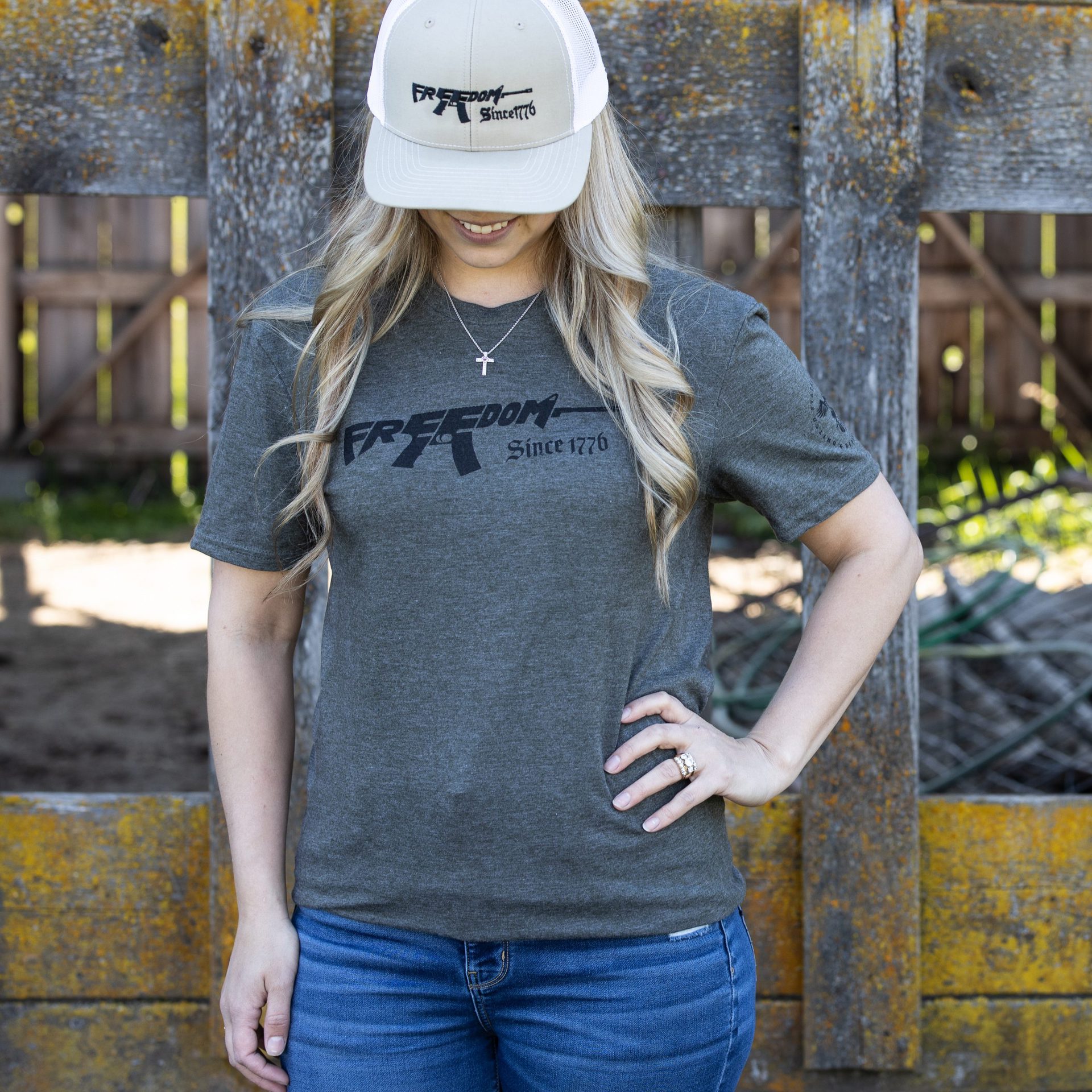 Woman wearing olive green Freedom Rifle T-shirt from United States of American's Republic USOAR