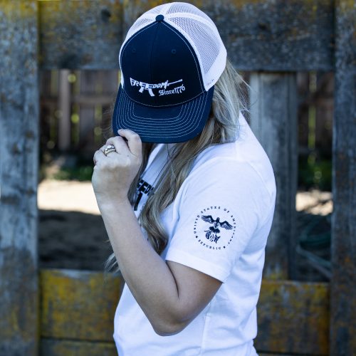 Freedom Rifle womens white sleeve Woman wearing a white Freedom Rifle USOAR T-Shirt from United States of American's Republic