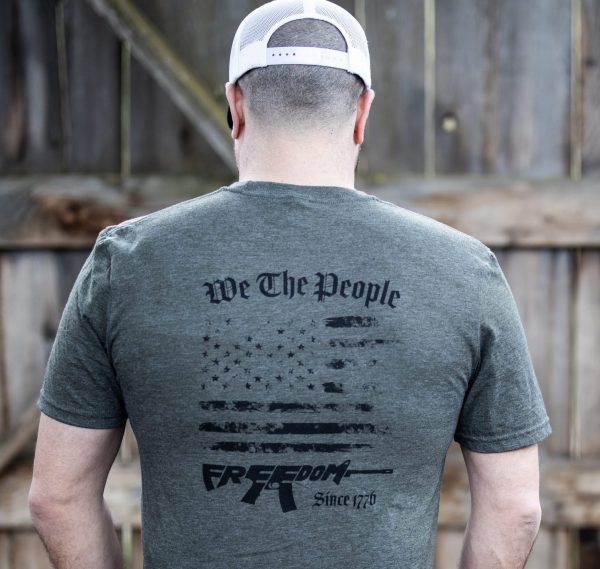 Man wearing olive green We The People T-shirt from United States of American's Republic USOAR